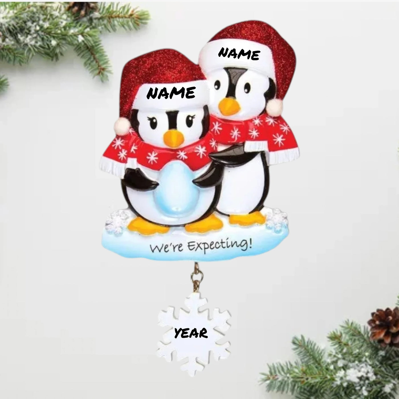  Personalized We're Expecting Penguins Christmas Ornament with customizable names and year, featuring two penguins dressed in festive holiday attire with a snowflake charm.