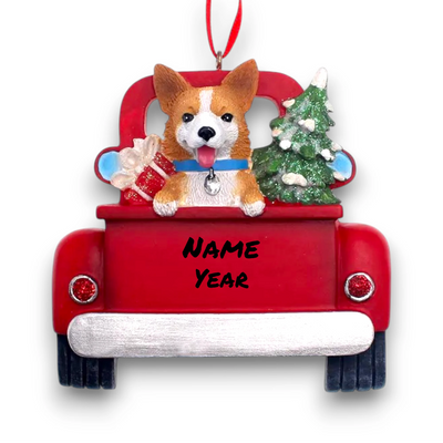 Personalized Welsh Corgi In Back Of Truck Christmas Ornament featuring a Welsh Corgi, Christmas tree, and presents in a red truck with customizable name and year.