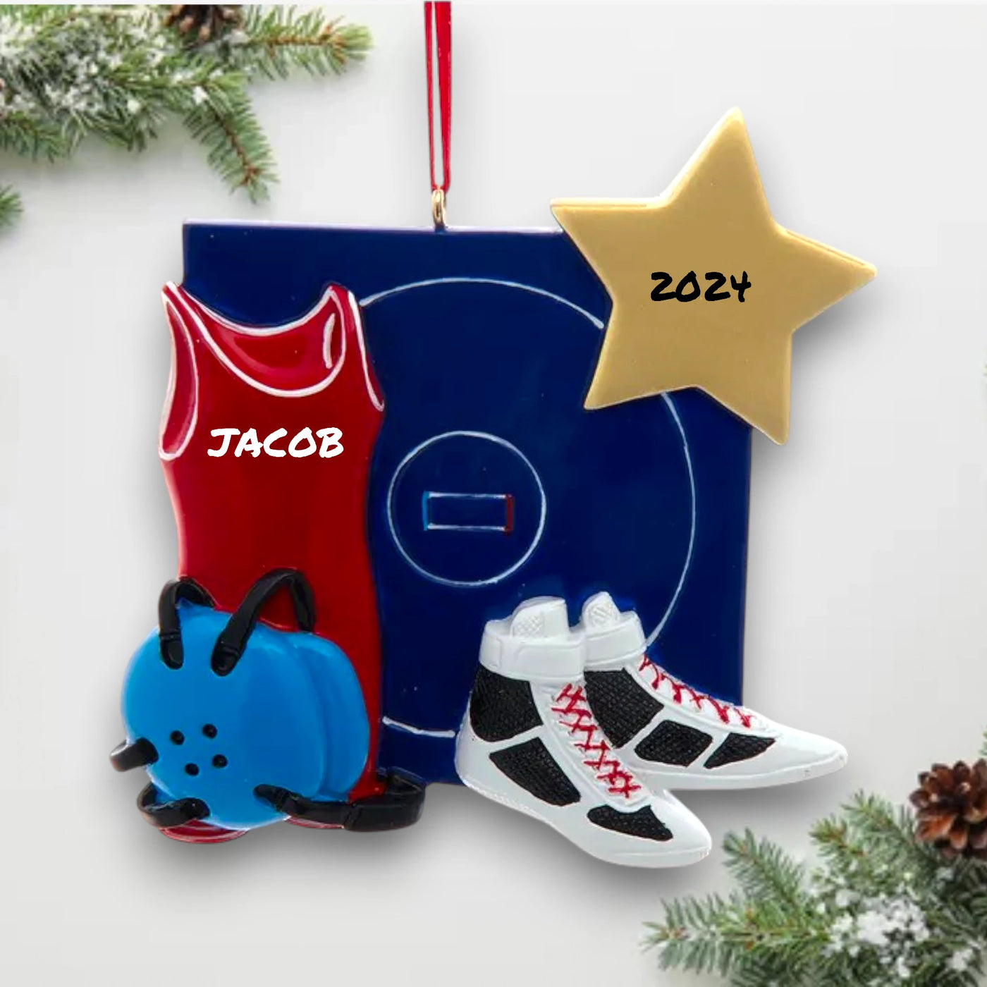 Personalized wrestling ornament featuring a red singlet, shoes, headgear, and wrestling mat with customizable name and year.