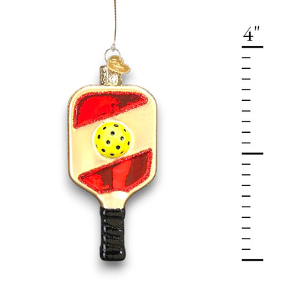 Pickleball paddle Christmas ornament featuring a yellow pickleball and vibrant red accents with glitter details, customizable with a name or year.