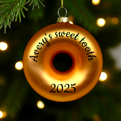Custom name and year hand-written on back of pink donut ornament