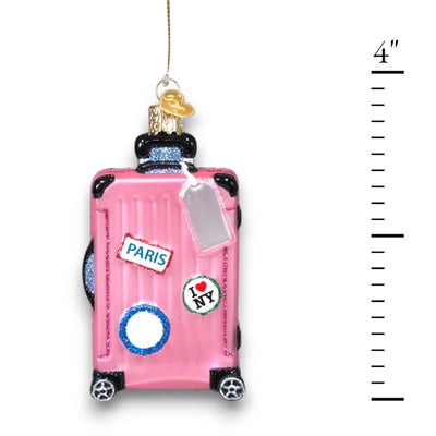 Personalized Pink Rolling Suitcase Christmas Ornament featuring a pink suitcase with travel stickers, glitter details, and a silver luggage tag, customizable with a name or year.