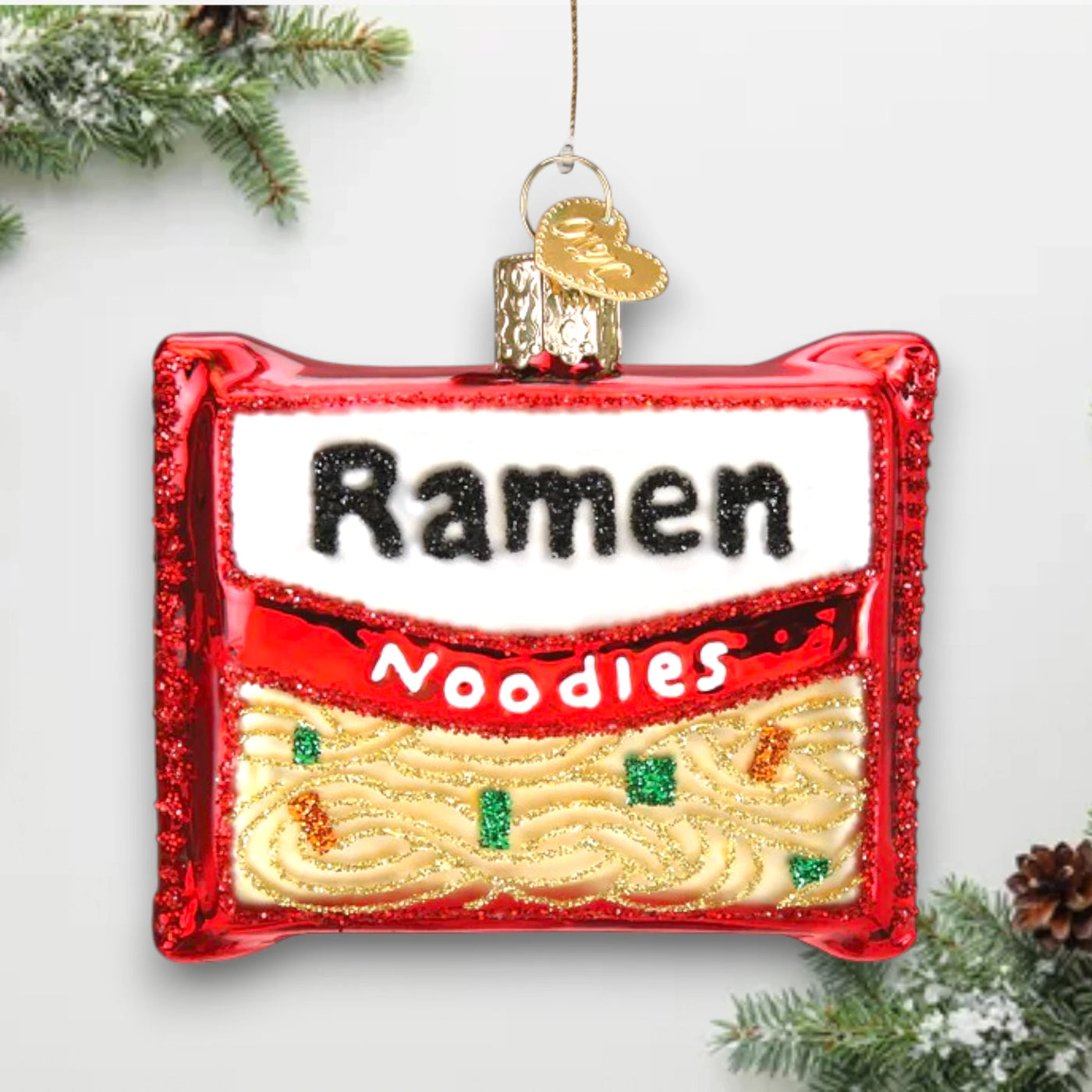 Ramen noodles Christmas ornament featuring a red and white package with glitter details, customizable with name and year.