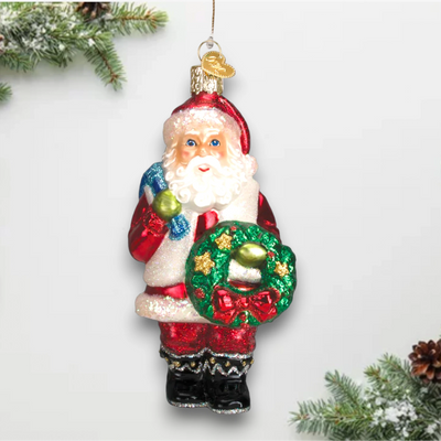 Personalized Santa With Wreath Christmas Ornament featuring Santa Claus holding a green wreath with golden stars and a red bow, customizable with name and year.