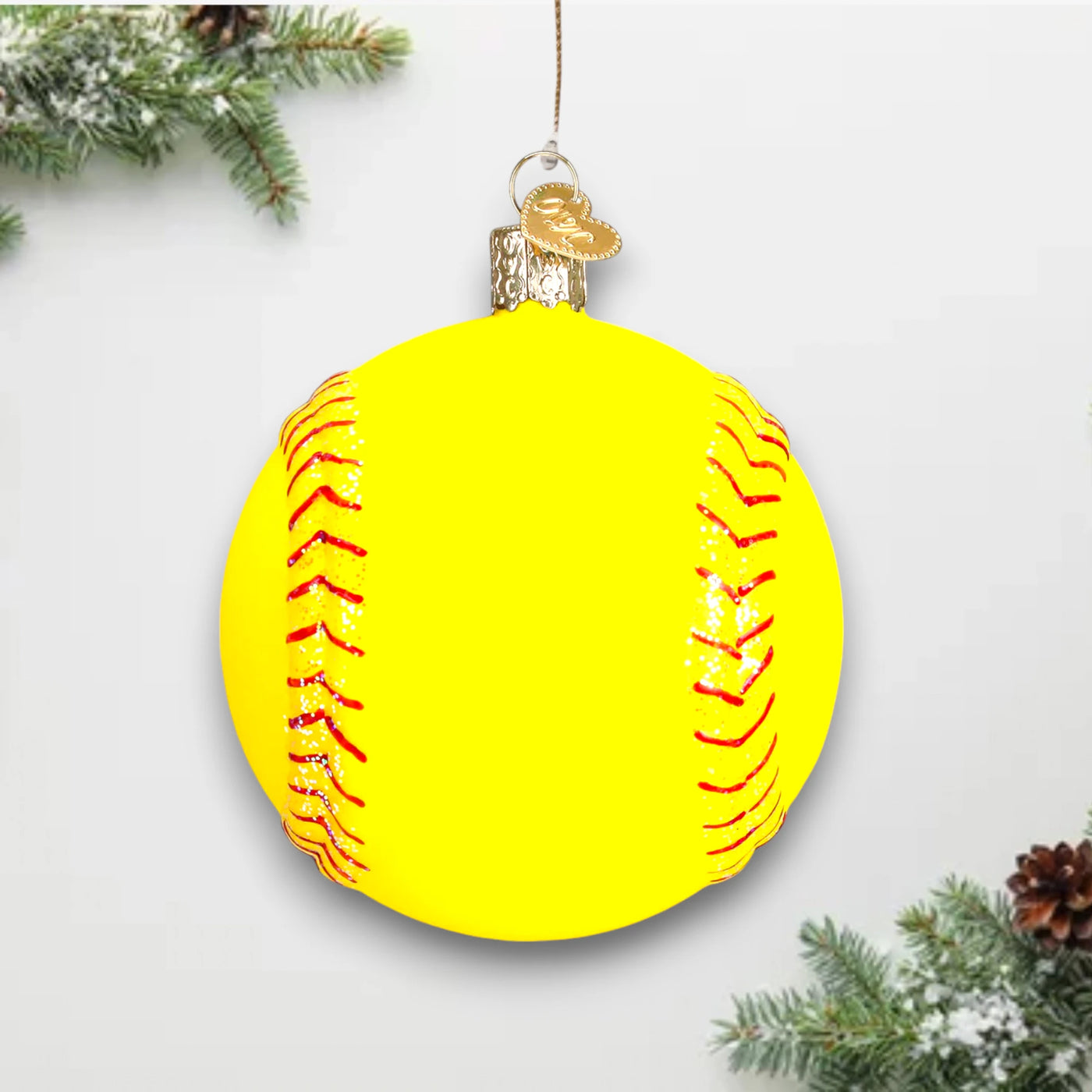 Bright yellow softball Christmas ornament with red stitching and glitter accents, customizable with name and year.