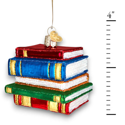 Christmas ornament featuring a stack of books in red, blue, and green with sparkling glitter accents, ideal for book lovers and teachers.