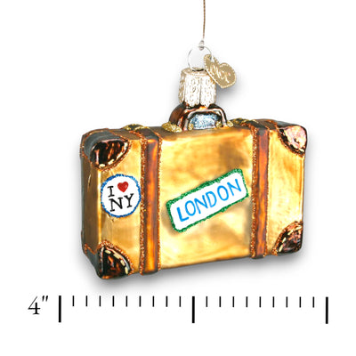 Golden suitcase Christmas ornament with travel destination stickers for Rome, Paris, London, and New York, decorated with glitter details.